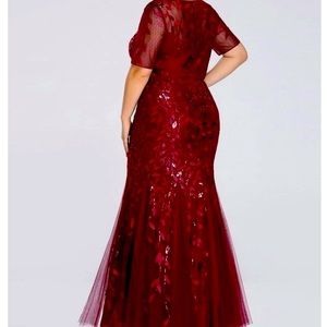 Beautiful cranberry full length gown with a shiny sequin leaf detail.